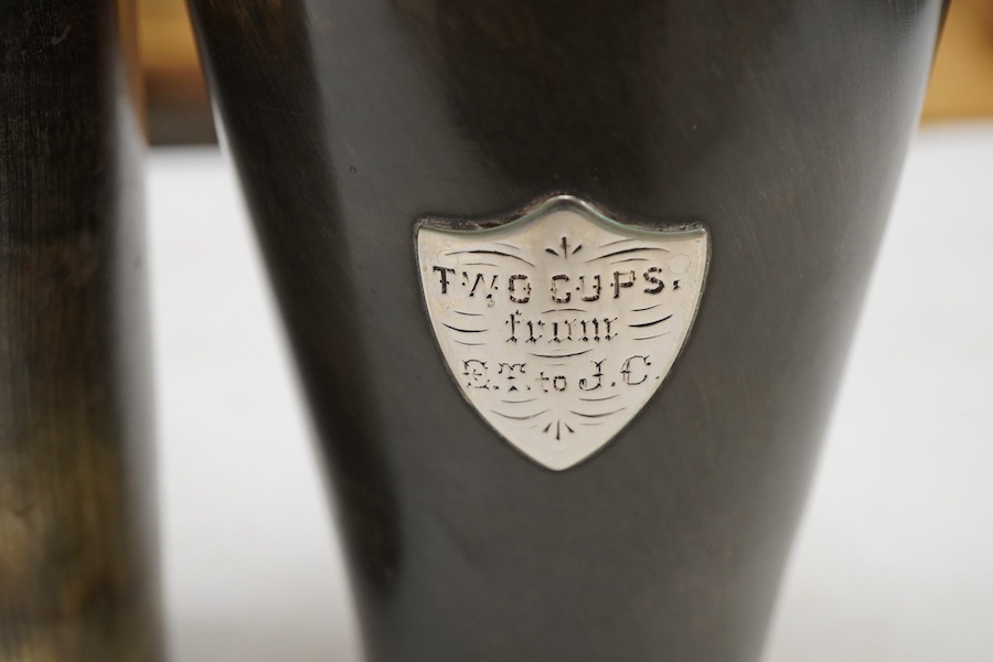 Two Victorian silver mounted horn beakers, by Atkin Brothers, Sheffield, 1882 (split), 14.2cm, and Sheffield, 1884, with shield appliqué, 12.6cm.